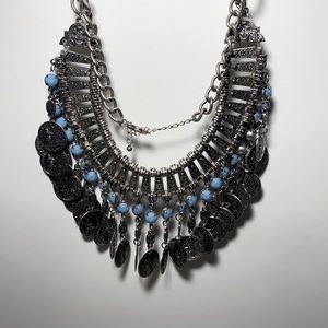 Silver colored necklace with turquoise color beads and Roman like medallions.